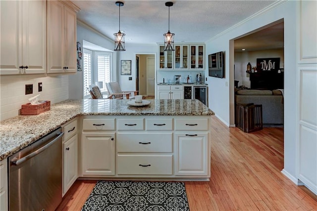 kitchen featuring hanging light fixtures, stainless steel dishwasher, light hardwood / wood-style flooring, and kitchen peninsula