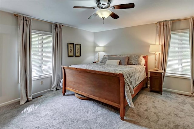 bedroom with ceiling fan and light colored carpet