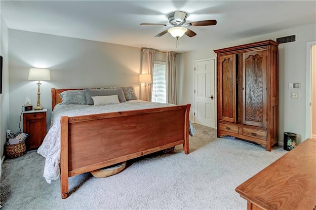 bedroom with ceiling fan and light colored carpet