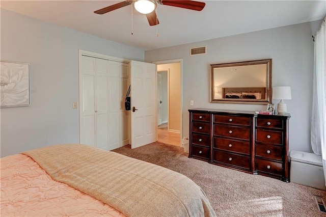 bedroom featuring light carpet, a closet, and ceiling fan