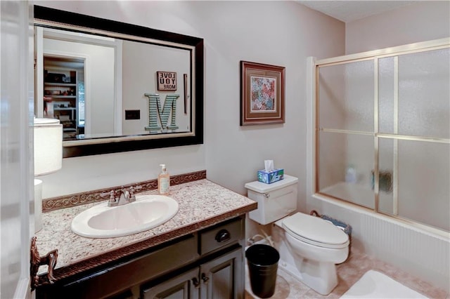 full bathroom featuring combined bath / shower with glass door, vanity, and toilet