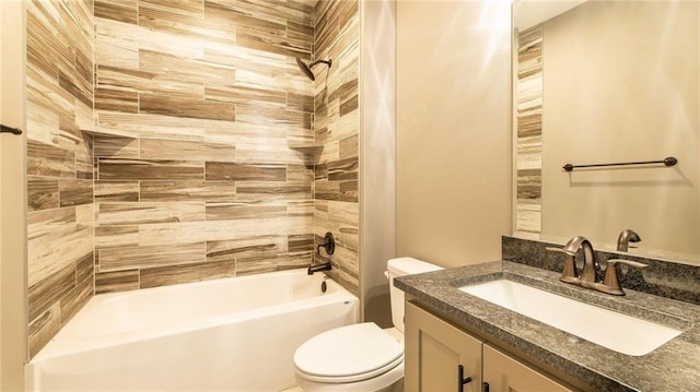 full bathroom featuring toilet, tiled shower / bath combo, and vanity