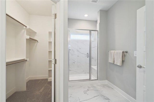 bathroom featuring a shower with door