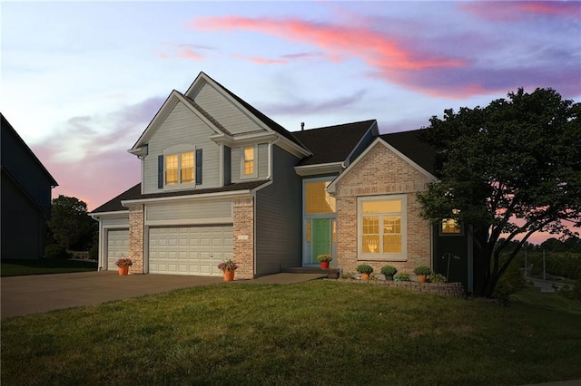 view of front of property featuring a garage and a lawn