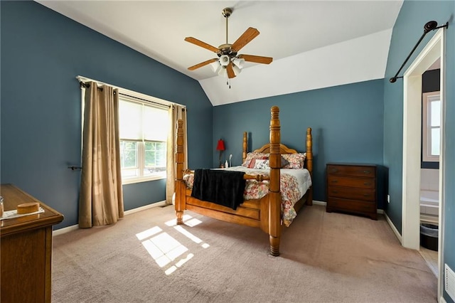 bedroom with ceiling fan, light colored carpet, and vaulted ceiling