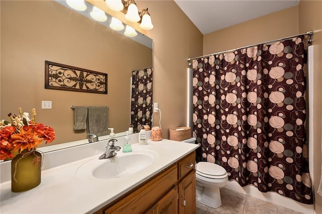 bathroom with curtained shower, vanity, toilet, and tile patterned floors