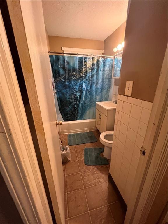 full bathroom featuring vanity, tile patterned floors, toilet, and shower / bath combo