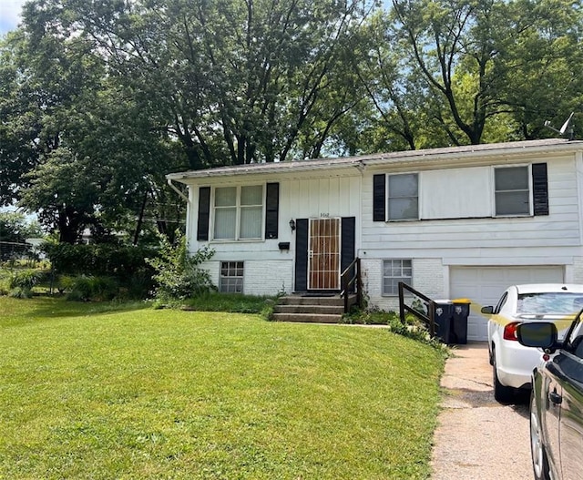 bi-level home featuring a garage and a front lawn