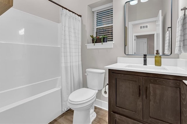 5830 Hunter Ct, Raytown, MO 64133 - full bathroom with visible vents, toilet, vanity, and wood finished floors