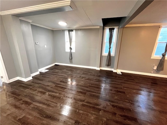 basement featuring ornamental molding, dark wood-type flooring, and a healthy amount of sunlight