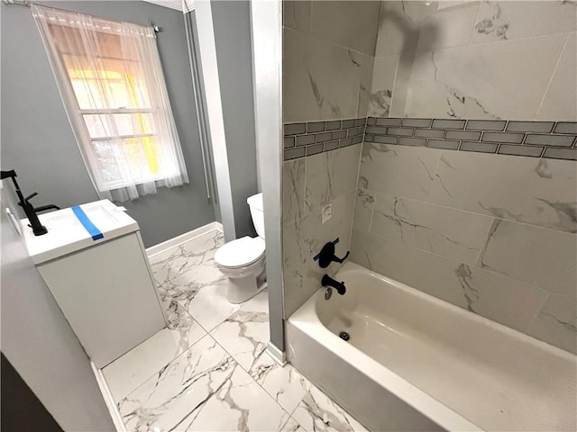 full bathroom with toilet, vanity, and tiled shower / bath