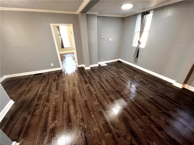 spare room with crown molding and dark hardwood / wood-style flooring