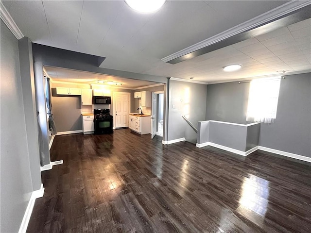 unfurnished living room featuring dark hardwood / wood-style flooring and ornamental molding