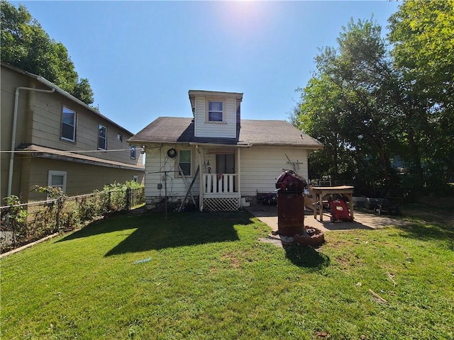 view of front of property with a patio and a front yard