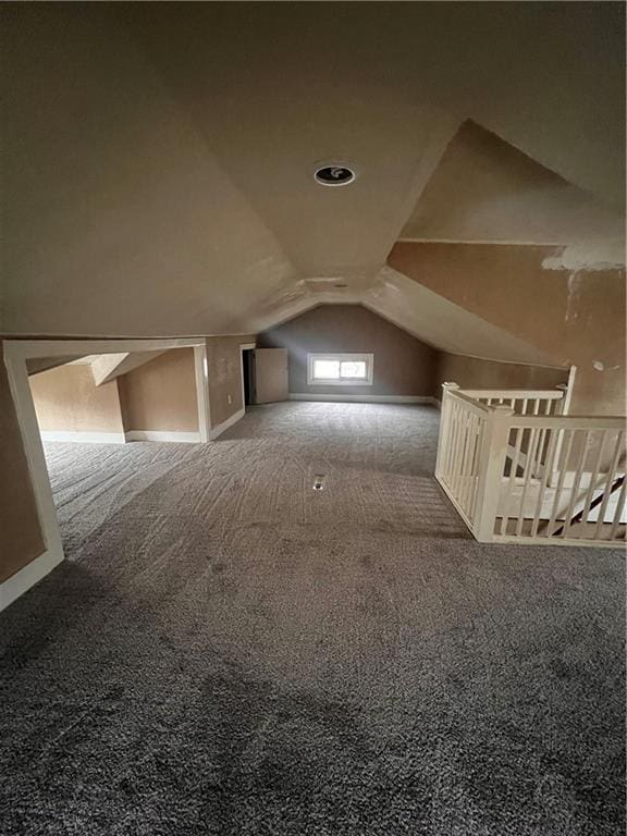 bonus room featuring carpet floors and vaulted ceiling