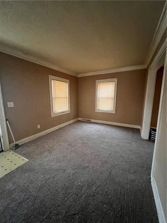 carpeted spare room with a textured ceiling and ornamental molding