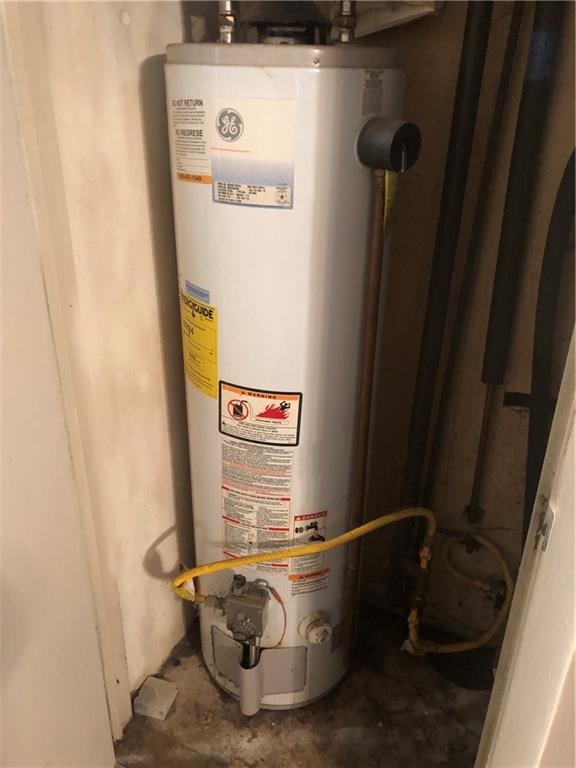 utility room featuring gas water heater