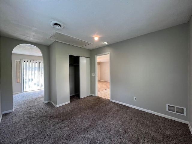 unfurnished bedroom with carpet and a closet