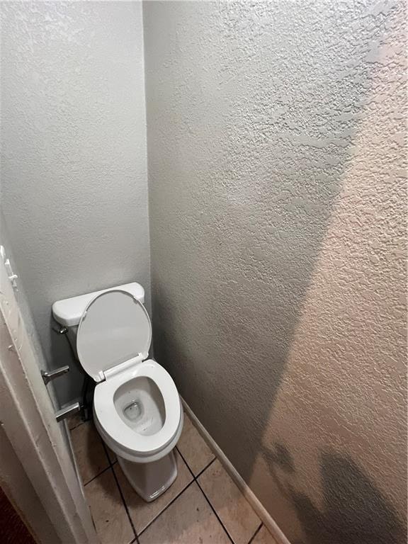 bathroom with tile patterned flooring and toilet