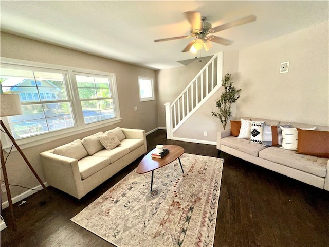 living room featuring ceiling fan and dark wood-type flooring