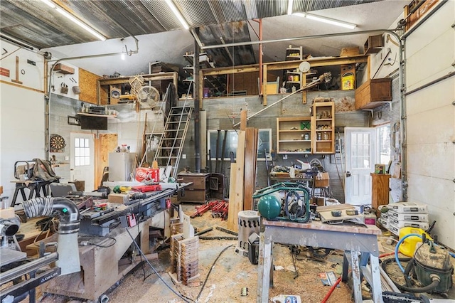 miscellaneous room with concrete flooring and a workshop area