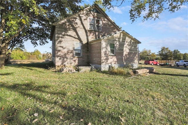 view of property exterior with a yard