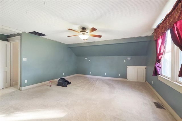 bonus room featuring ceiling fan, light colored carpet, and vaulted ceiling