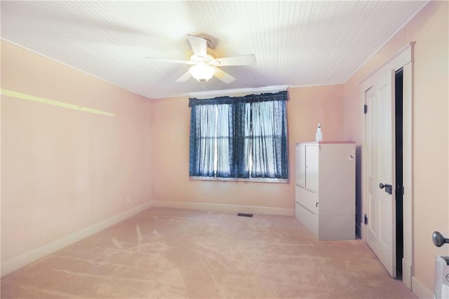 unfurnished bedroom with light colored carpet and ceiling fan