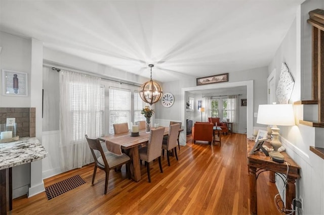 dining room with hardwood / wood-style floors, a chandelier, and plenty of natural light