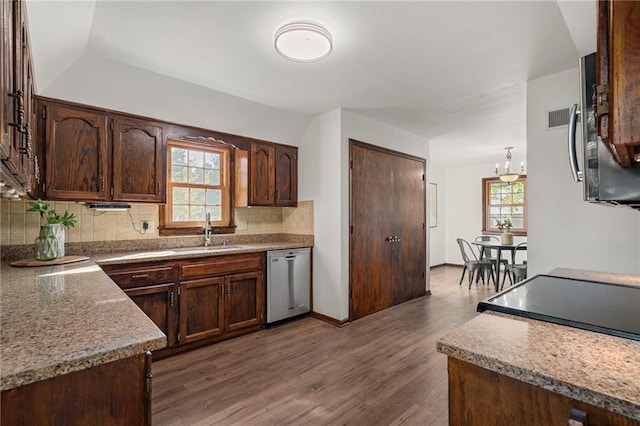 3438 N 123rd St, Kansas City, KS 66109 - kitchen featuring stainless steel dishwasher, a sink, backsplash, dark wood-type flooring, and visible vents
