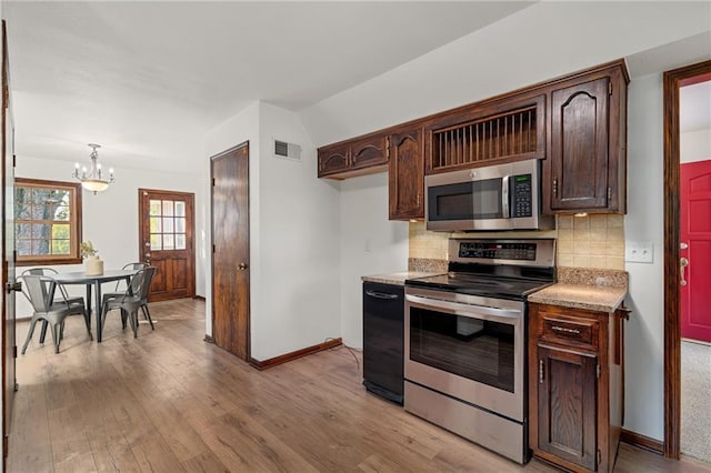 3438 N 123rd St, Kansas City, KS 66109 - kitchen with light wood-style flooring, visible vents, backsplash, a chandelier, and appliances with stainless steel finishes