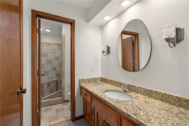 3438 N 123rd St, Kansas City, KS 66109 - bathroom featuring vanity, baseboards, a tile shower, toilet, and recessed lighting