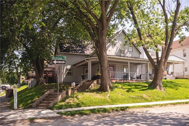 view of front of home featuring covered porch and a front lawn