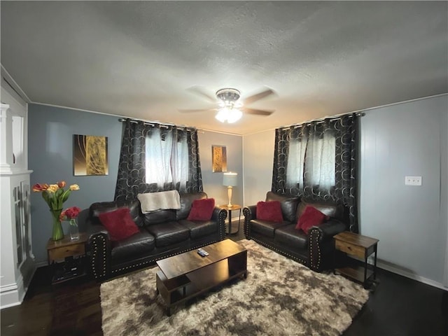 living room featuring ceiling fan and dark hardwood / wood-style flooring