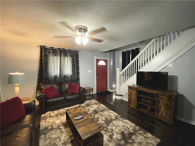 living room featuring ceiling fan and dark hardwood / wood-style floors