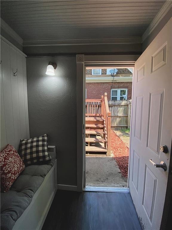 doorway featuring ornamental molding and dark hardwood / wood-style flooring