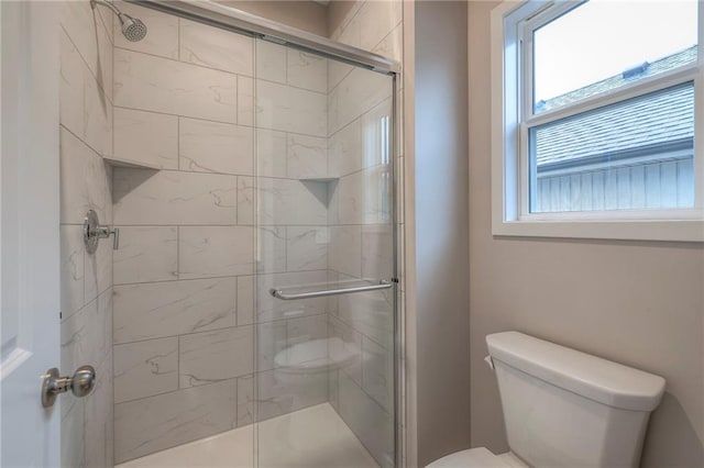 bathroom with walk in shower and toilet