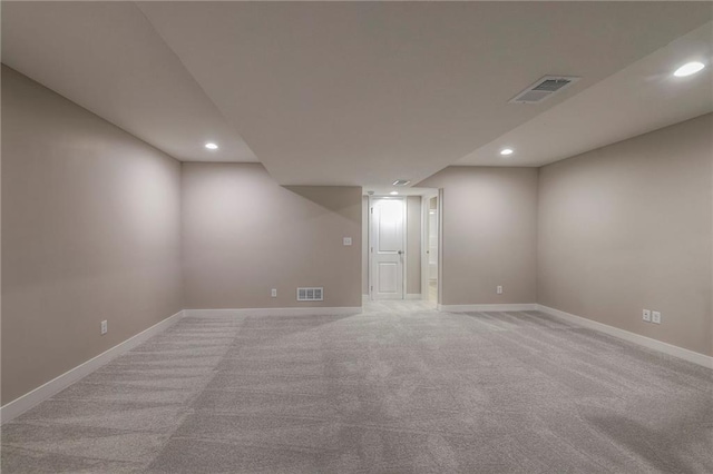 basement featuring light colored carpet