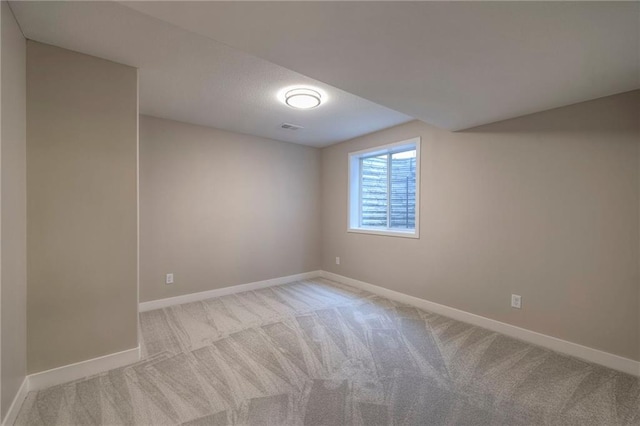 spare room featuring light colored carpet