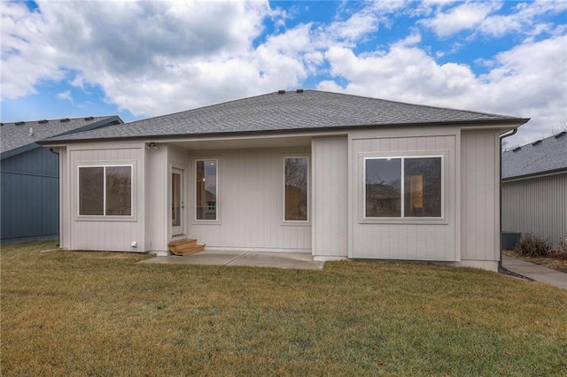 rear view of property with a lawn and a patio