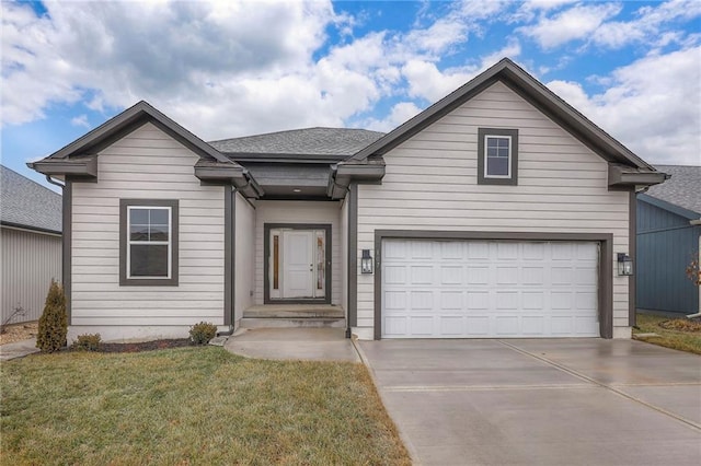 view of front facade with a garage and a front lawn