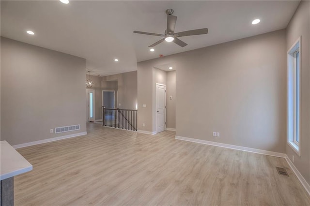 unfurnished living room with light hardwood / wood-style floors and ceiling fan