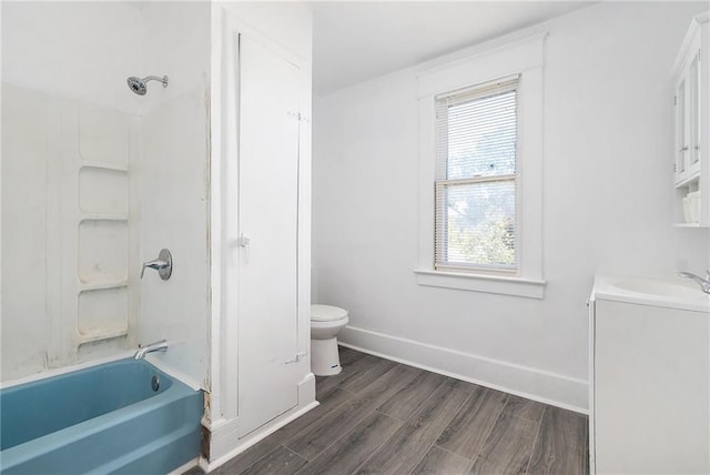 full bath featuring baseboards, toilet,  shower combination, vanity, and wood finished floors