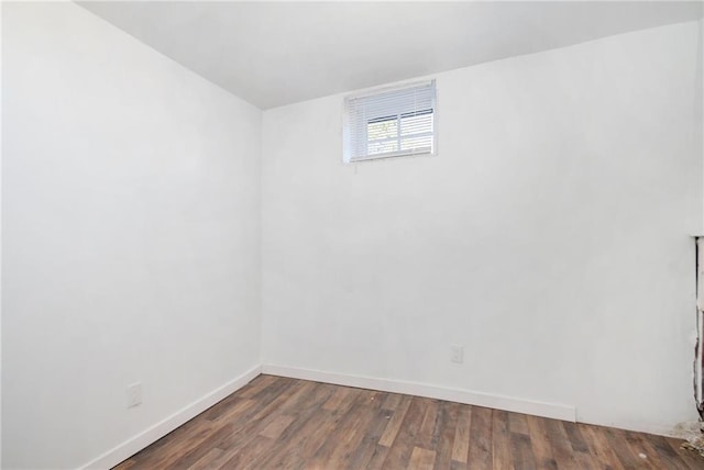 spare room featuring wood finished floors and baseboards
