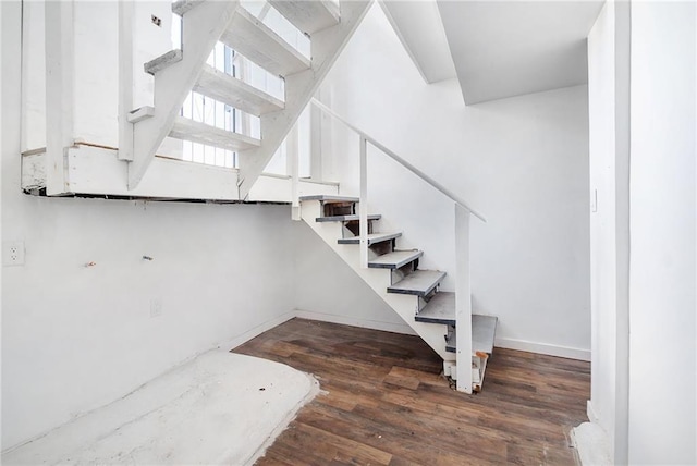 stairs with baseboards and wood finished floors