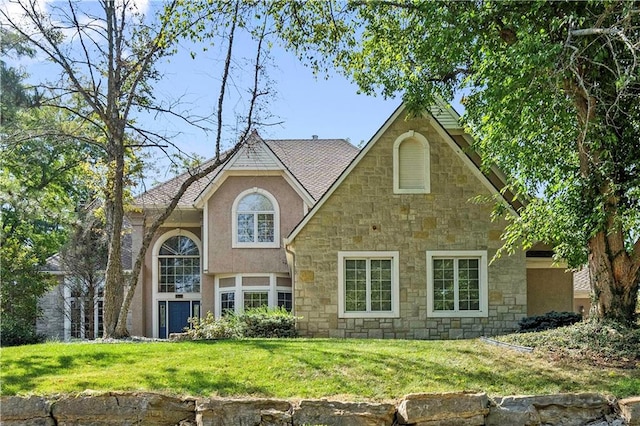 rear view of house featuring a lawn