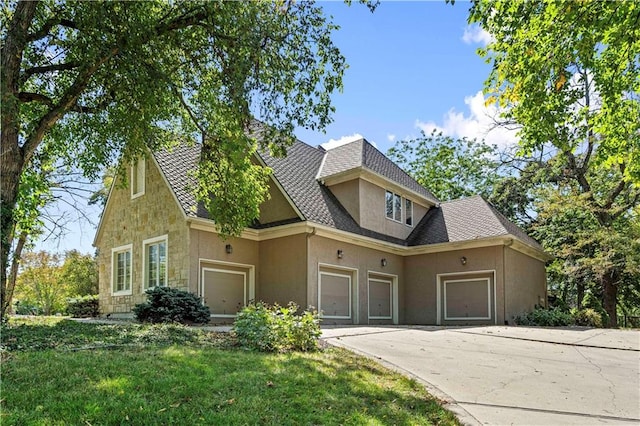 view of front of property with a garage and a front yard