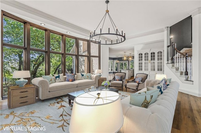 living room featuring a towering ceiling, hardwood / wood-style floors, and a chandelier