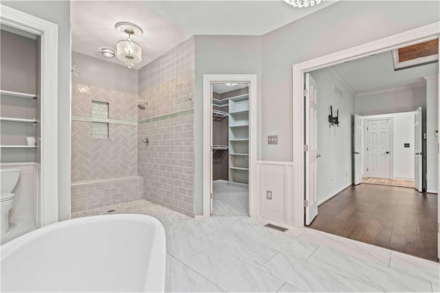 bathroom with plus walk in shower, wood-type flooring, ornamental molding, and toilet