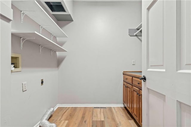 washroom with light hardwood / wood-style floors, electric dryer hookup, and hookup for a washing machine